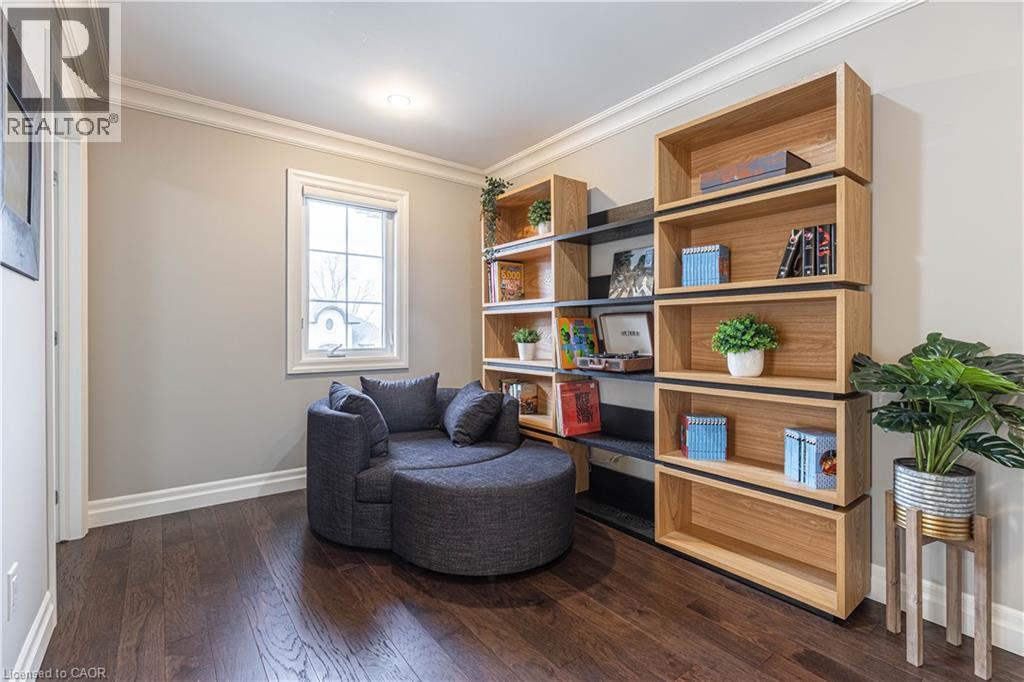 Living area with ornamental molding and dark wood-style flooring - 2719 Torrey Pines Way, London, ON - Indoor