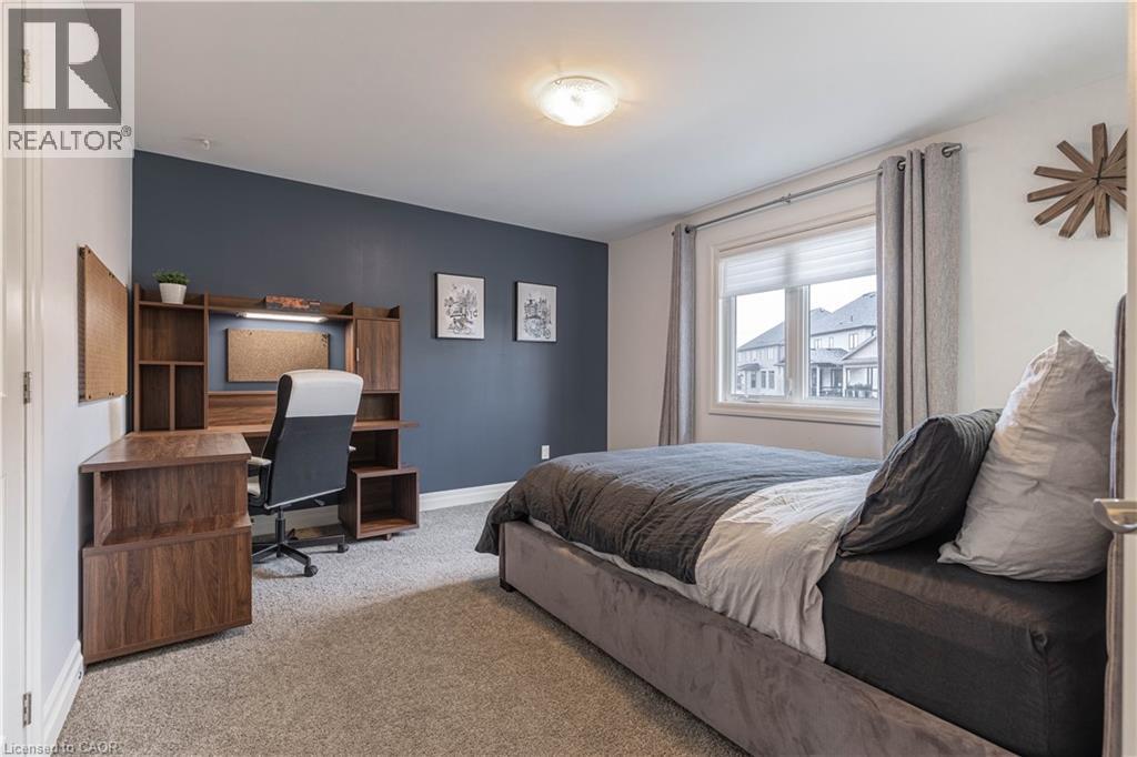 Bedroom featuring an accent wall, carpet flooring, and a desk - 2719 Torrey Pines Way, London, ON - Indoor Photo Showing Bedroom