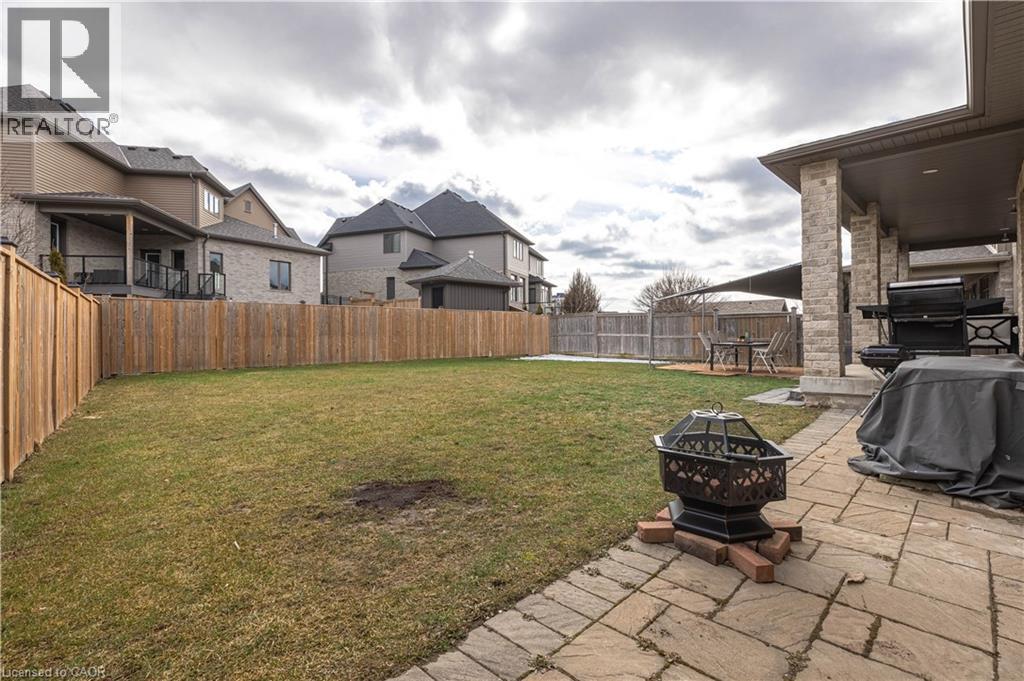 Fenced backyard with a patio, an outdoor fire pit, and a residential view - 2719 Torrey Pines Way, London, ON - Outdoor With Deck Patio Veranda