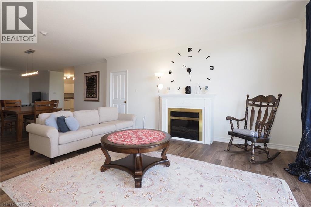 255 Keats Way Unit# 701, Waterloo, ON - Indoor Photo Showing Living Room With Fireplace