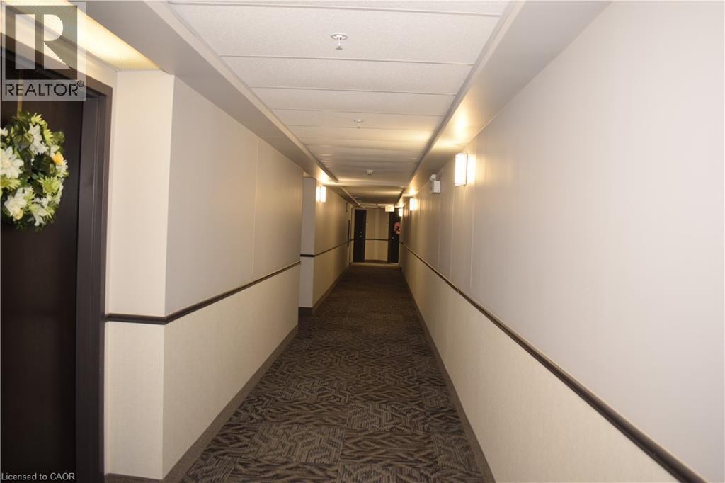 Corridor with dark colored carpet - 776 Laurelwood Drive Unit# 406, Waterloo, ON - Indoor Photo Showing Other Room