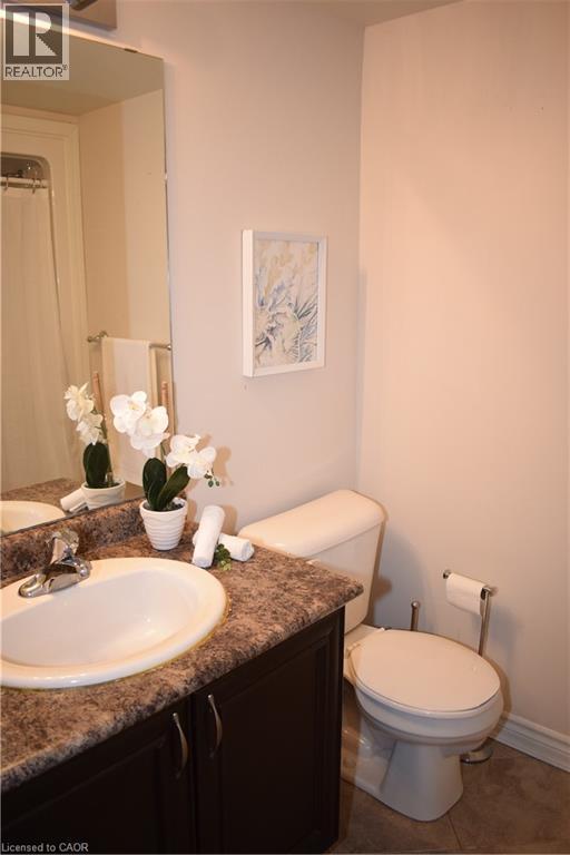 Bathroom featuring vanity, a shower with curtain, and dark tile patterned floors - 776 Laurelwood Drive Unit# 406, Waterloo, ON - Indoor Photo Showing Bathroom