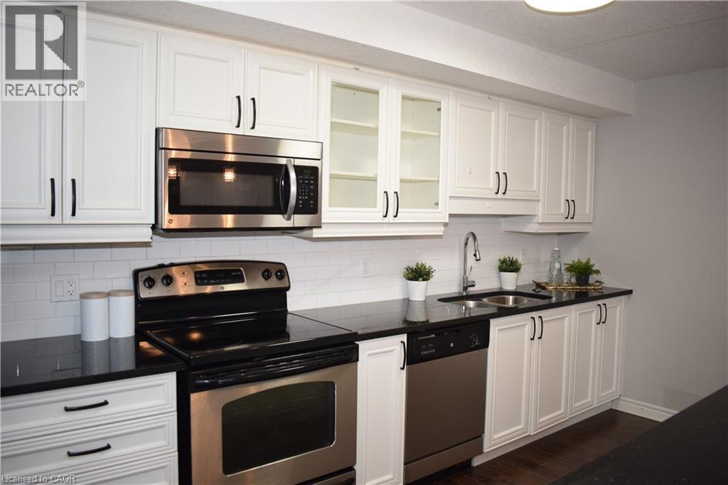 Kitchen featuring stainless steel appliances and white cabinets - 776 Laurelwood Drive Unit# 406, Waterloo, ON - Indoor Photo Showing Kitchen With Stainless Steel Kitchen With Double Sink