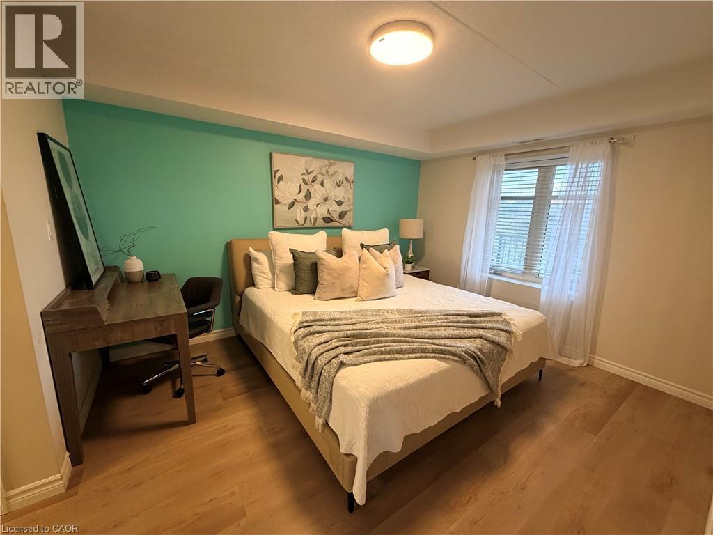 Bedroom featuring wood finished floors - 776 Laurelwood Drive Unit# 406, Waterloo, ON - Indoor Photo Showing Bedroom