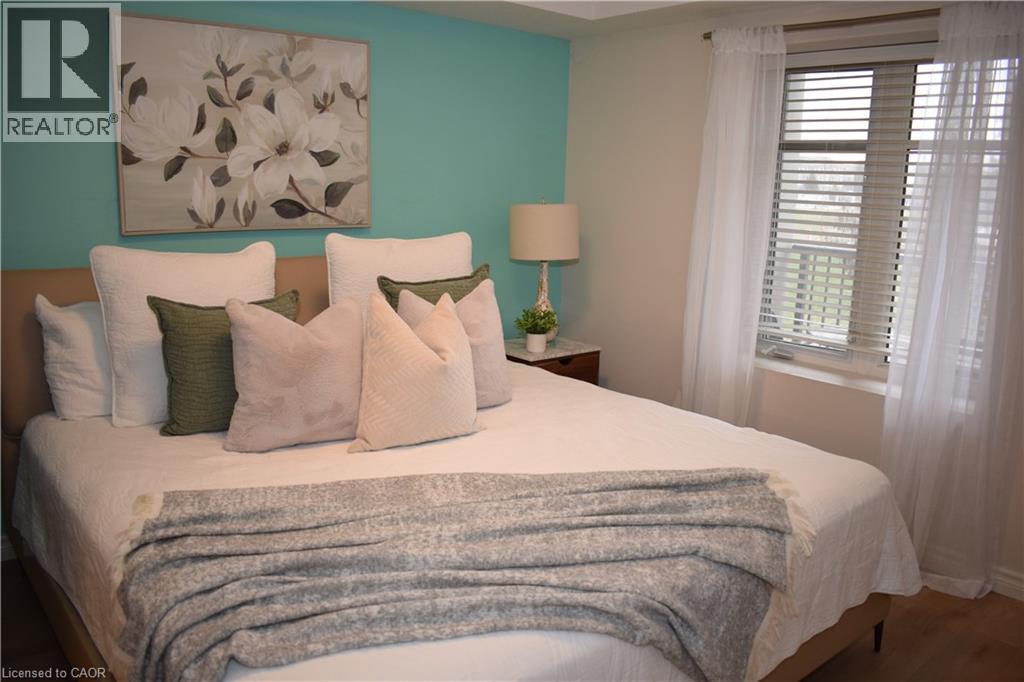 Bedroom with wood finished floors - 776 Laurelwood Drive Unit# 406, Waterloo, ON - Indoor Photo Showing Bedroom