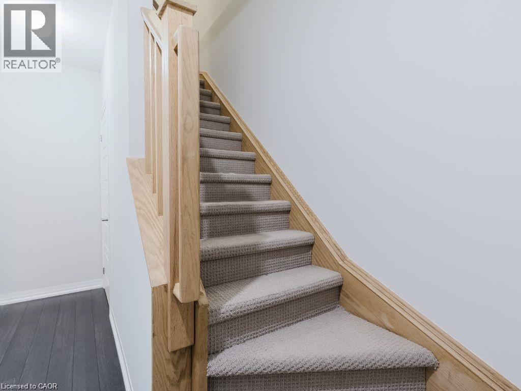 Stairway featuring baseboards and wood finished floors - 1206 Main Street E Unit# 113, Milton, ON - Indoor Photo Showing Other Room