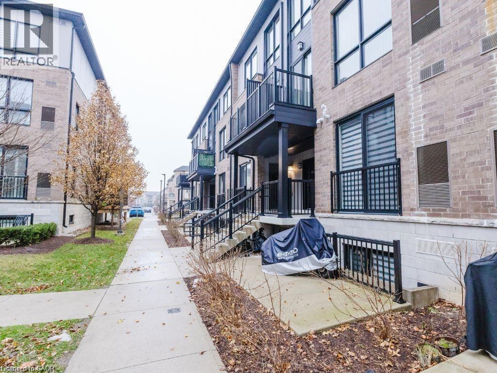 View of community featuring a balcony and a patio area - 1206 Main Street E Unit# 113, Milton, ON - Outdoor