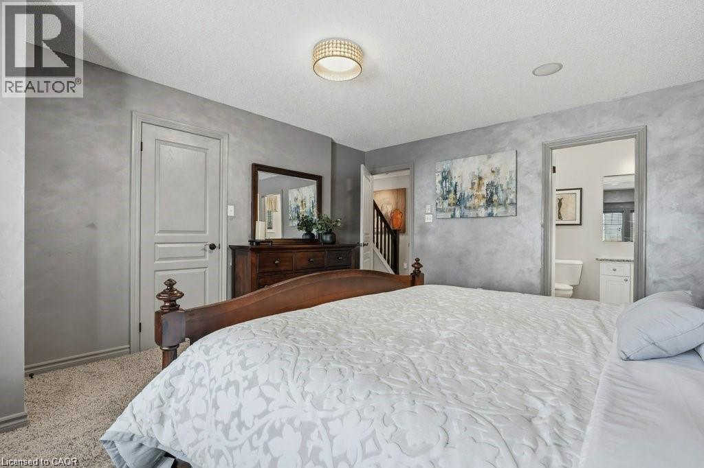 Impressive primary bedroom with walk-in closet and private ensuite - 26 Helena Feasby Street, Kitchener, ON - Indoor Photo Showing Bedroom