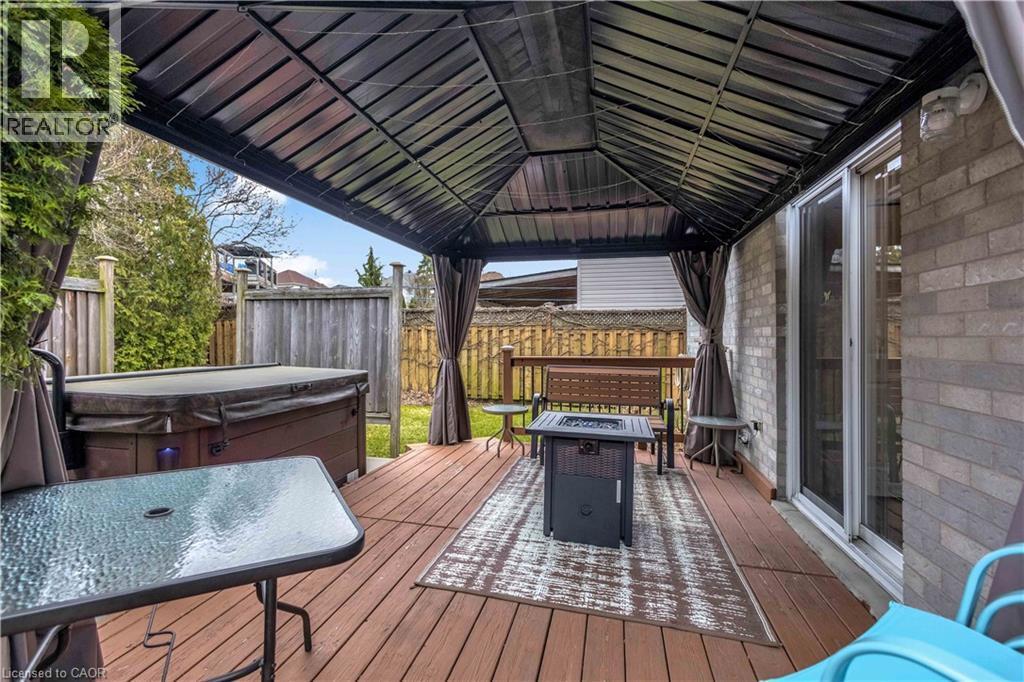 Deck with a hot tub, an outdoor fire pit, and outdoor dining area - 640 Acadia Drive, Hamilton, ON - Outdoor With Deck Patio Veranda With Exterior