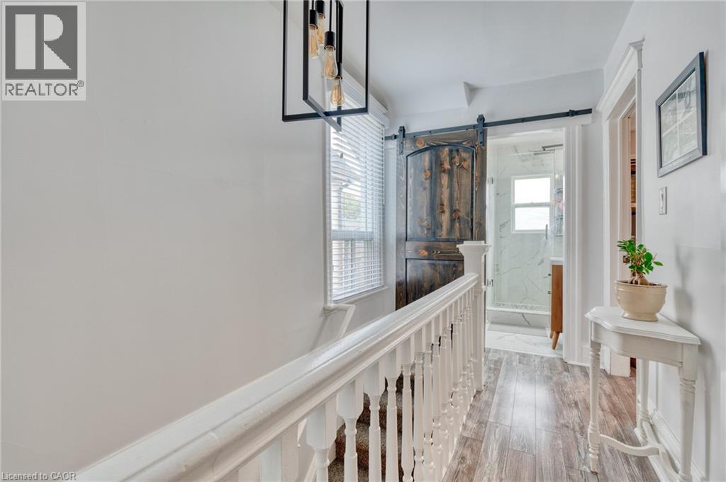 Hallway with a barn door and light wood finished floors - 37 Cliff Avenue, Hamilton, ON - Indoor Photo Showing Other Room
