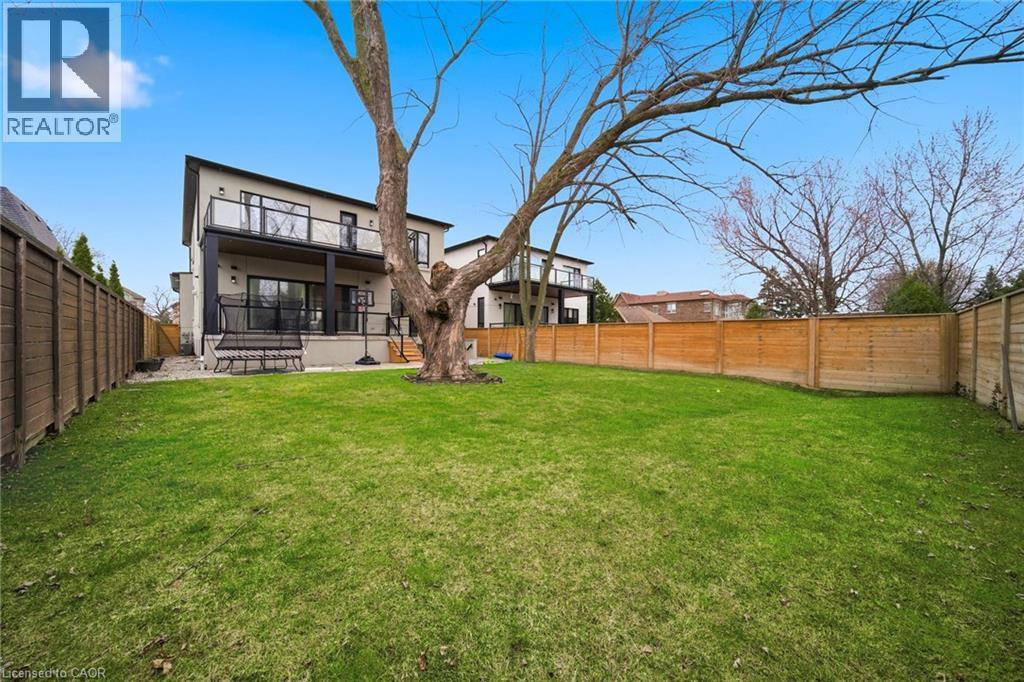 Back of property featuring a fenced backyard, a patio area, and a wooden deck - 2556 Glengarry Road, Mississauga, ON - Outdoor