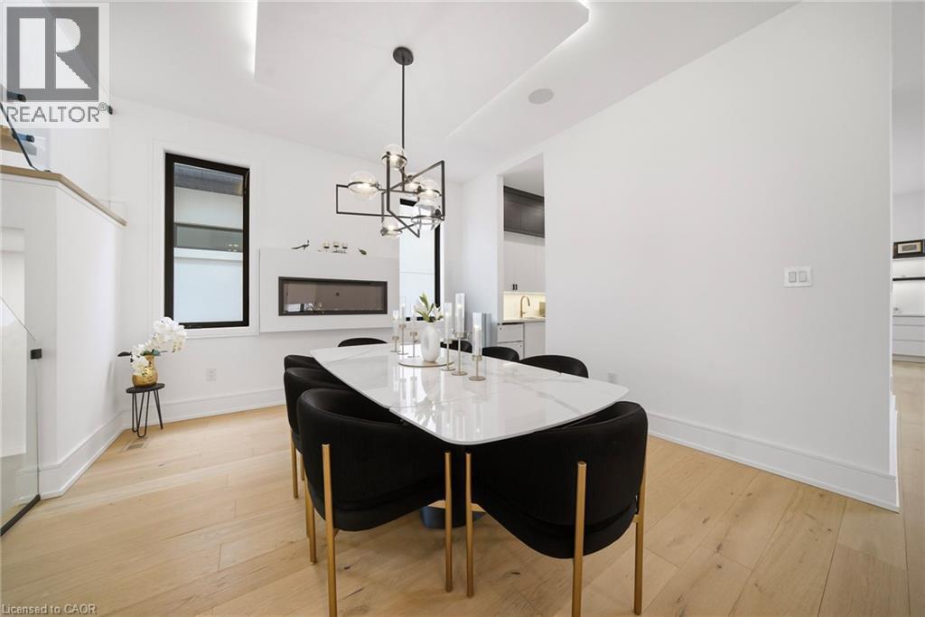 Dining room with suspended lighting and light wood finished floors - 2556 Glengarry Road, Mississauga, ON - Indoor Photo Showing Dining Room