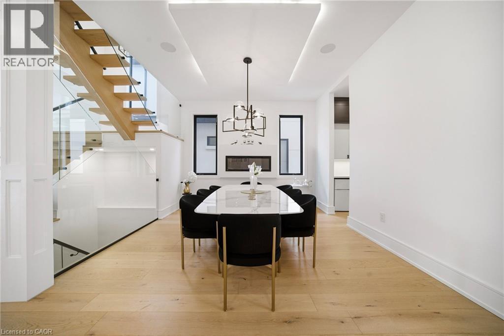 Dining space featuring light wood-type flooring and a chandelier - 2556 Glengarry Road, Mississauga, ON - Indoor Photo Showing Dining Room