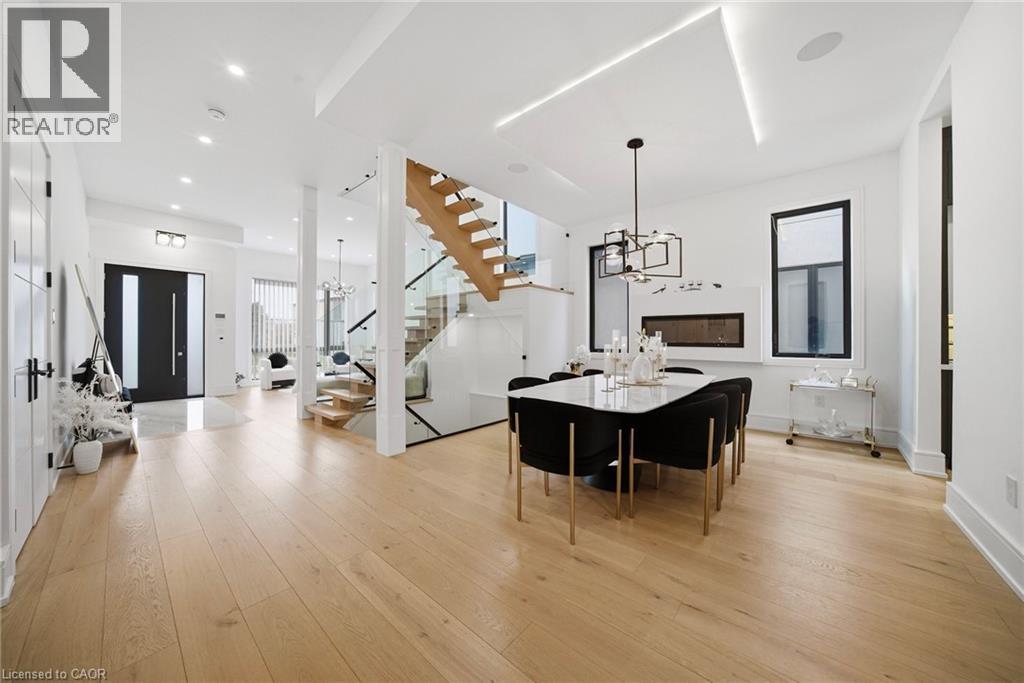 Dining area with hanging lights and light wood finished floors - 2556 Glengarry Road, Mississauga, ON - Indoor