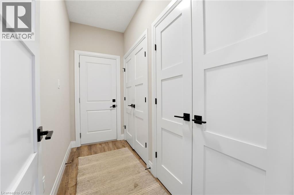 Doorway to outside with wood finished floors and baseboards - 39 Mill Race Crescent, St. Jacobs, ON - Indoor Photo Showing Other Room