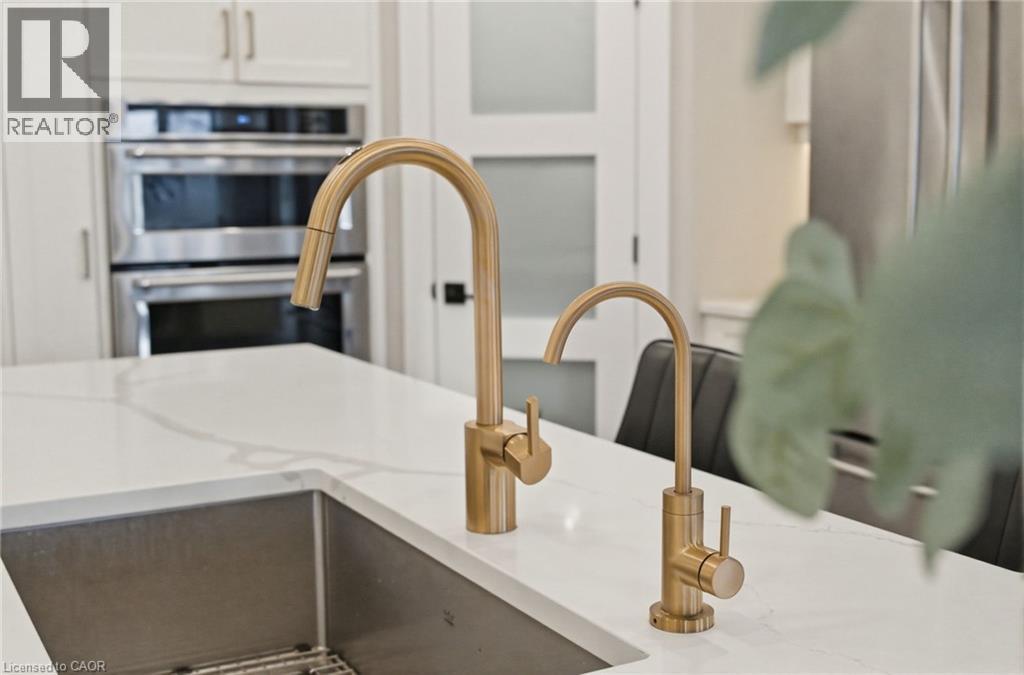 Kitchen view of double oven and light stone counters - 39 Mill Race Crescent, St. Jacobs, ON - Indoor Photo Showing Kitchen With Upgraded Kitchen