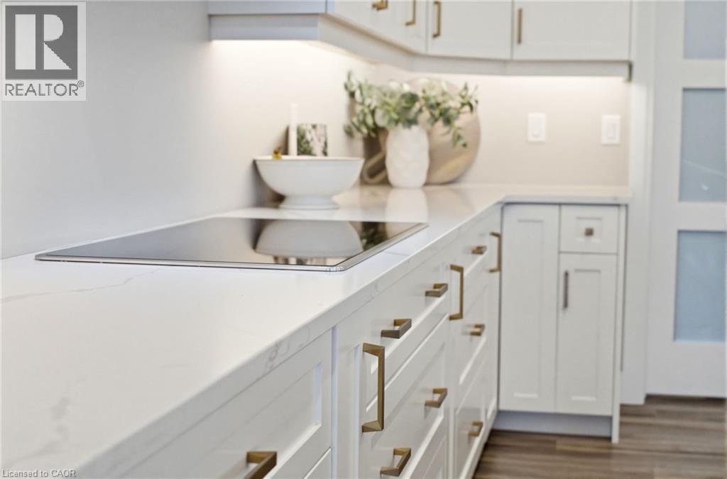 Bar area with white cabinets, black electric stovetop, and dark wood finished floors - 39 Mill Race Crescent, St. Jacobs, ON - Indoor Photo Showing Kitchen