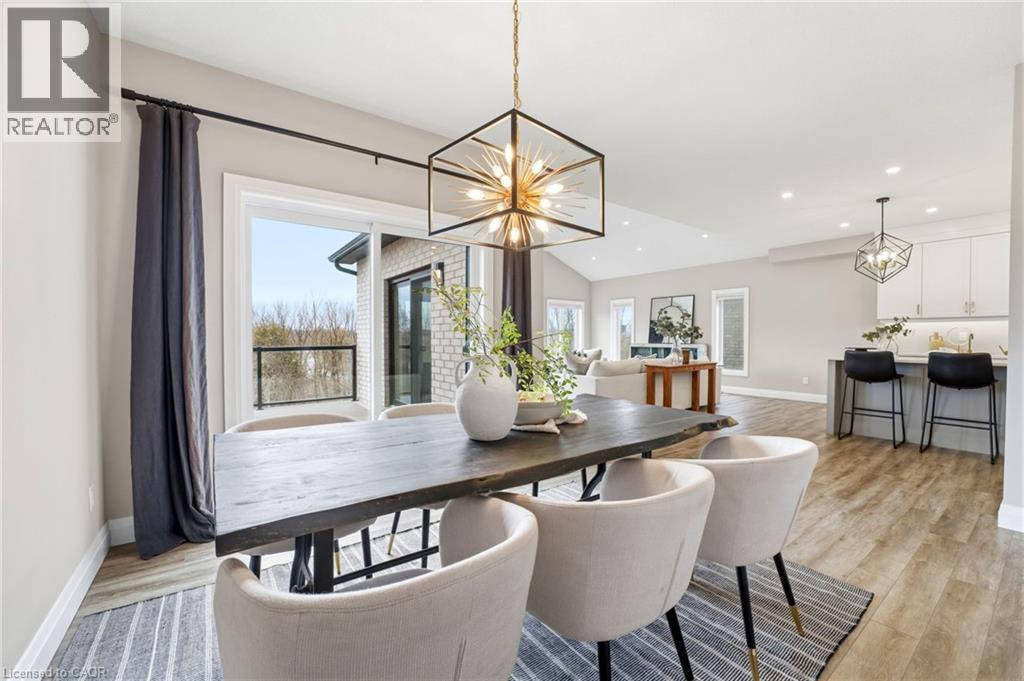 Dining area featuring suspended lighting, light wood finished floors, and vaulted ceiling - 39 Mill Race Crescent, St. Jacobs, ON - Indoor Photo Showing Dining Room
