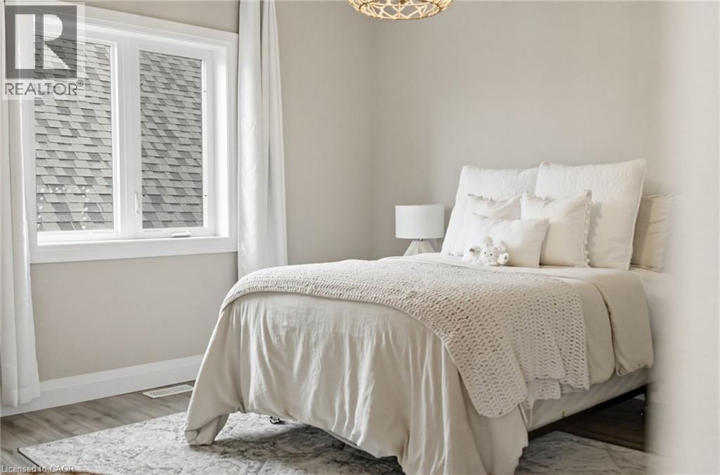 Bedroom with baseboards and wood finished floors - 39 Mill Race Crescent, St. Jacobs, ON - Indoor Photo Showing Bedroom