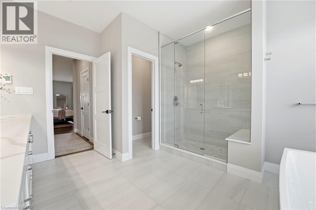 Full bath featuring vanity, a freestanding tub, ensuite bathroom, and a shower stall - 39 Mill Race Crescent, St. Jacobs, ON - Indoor Photo Showing Other Room