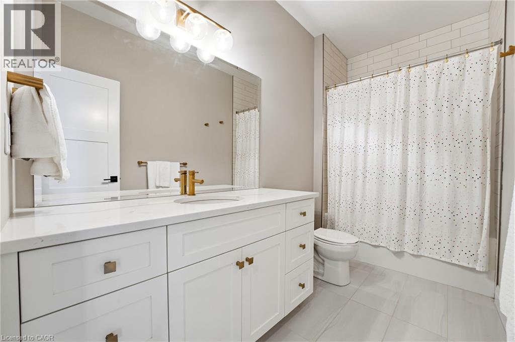 Bathroom featuring vanity and shower / tub combo - 39 Mill Race Crescent, St. Jacobs, ON - Indoor Photo Showing Bathroom