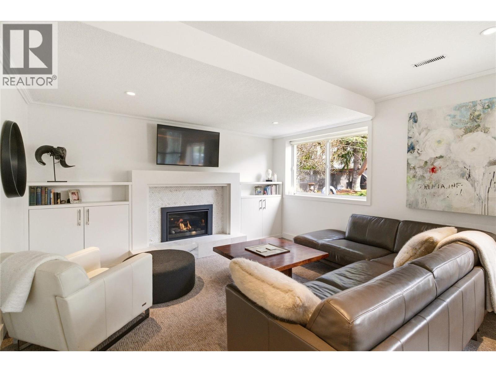 TV room - 4337 Dunvegan Court, Kelowna, BC - Indoor Photo Showing Living Room With Fireplace