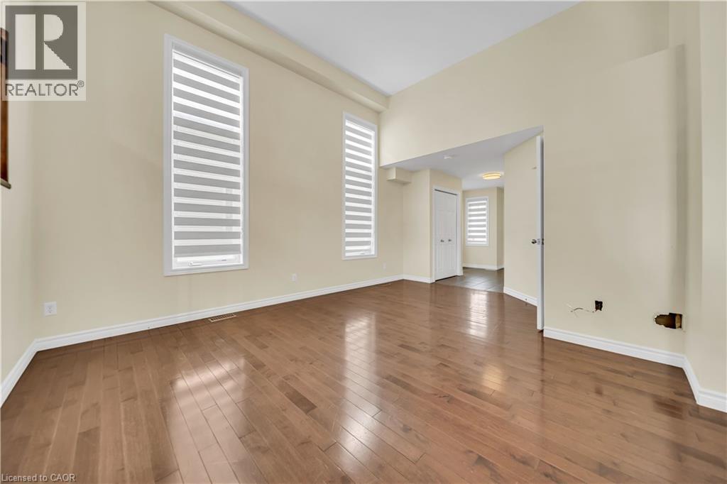 Unfurnished room featuring baseboards and dark wood finished floors - 51 Seabrook Drive, Kitchener, ON - Indoor Photo Showing Other Room