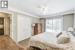 Bedroom featuring wood finished floors, a closet, ceiling fan, and access to outside -