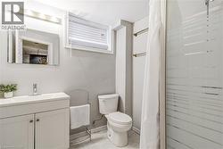 Bathroom with vanity, a stall shower, and light tile patterned floors -