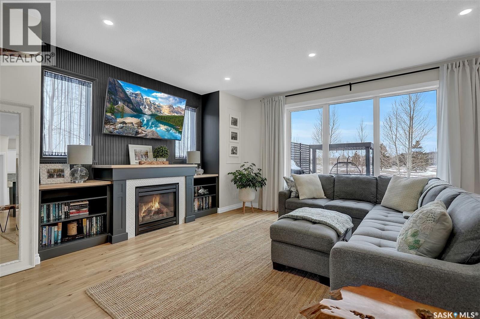 28 Emerald Creek Drive, White City, SK - Indoor Photo Showing Living Room With Fireplace