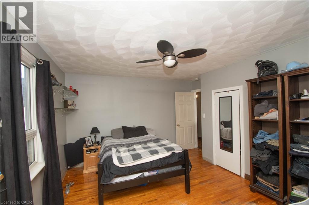 Bedroom featuring a ceiling fan and wood finished floors - 535 Mcdowell Road E, Simcoe, ON