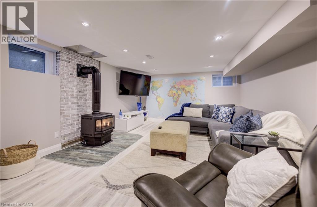 featuring a gas wood stove and recessed lighting - 27 Lowrey Avenue S, Cambridge, ON - Indoor Photo Showing Other Room With Fireplace