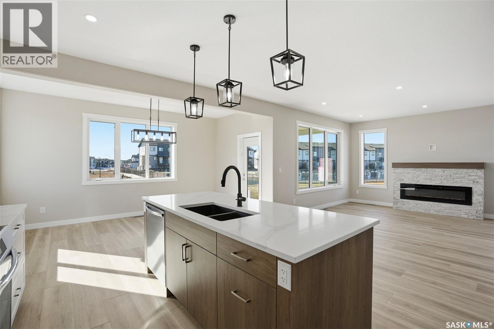 435 Sharma Crescent, Saskatoon, SK - Indoor Photo Showing Kitchen With Fireplace With Double Sink