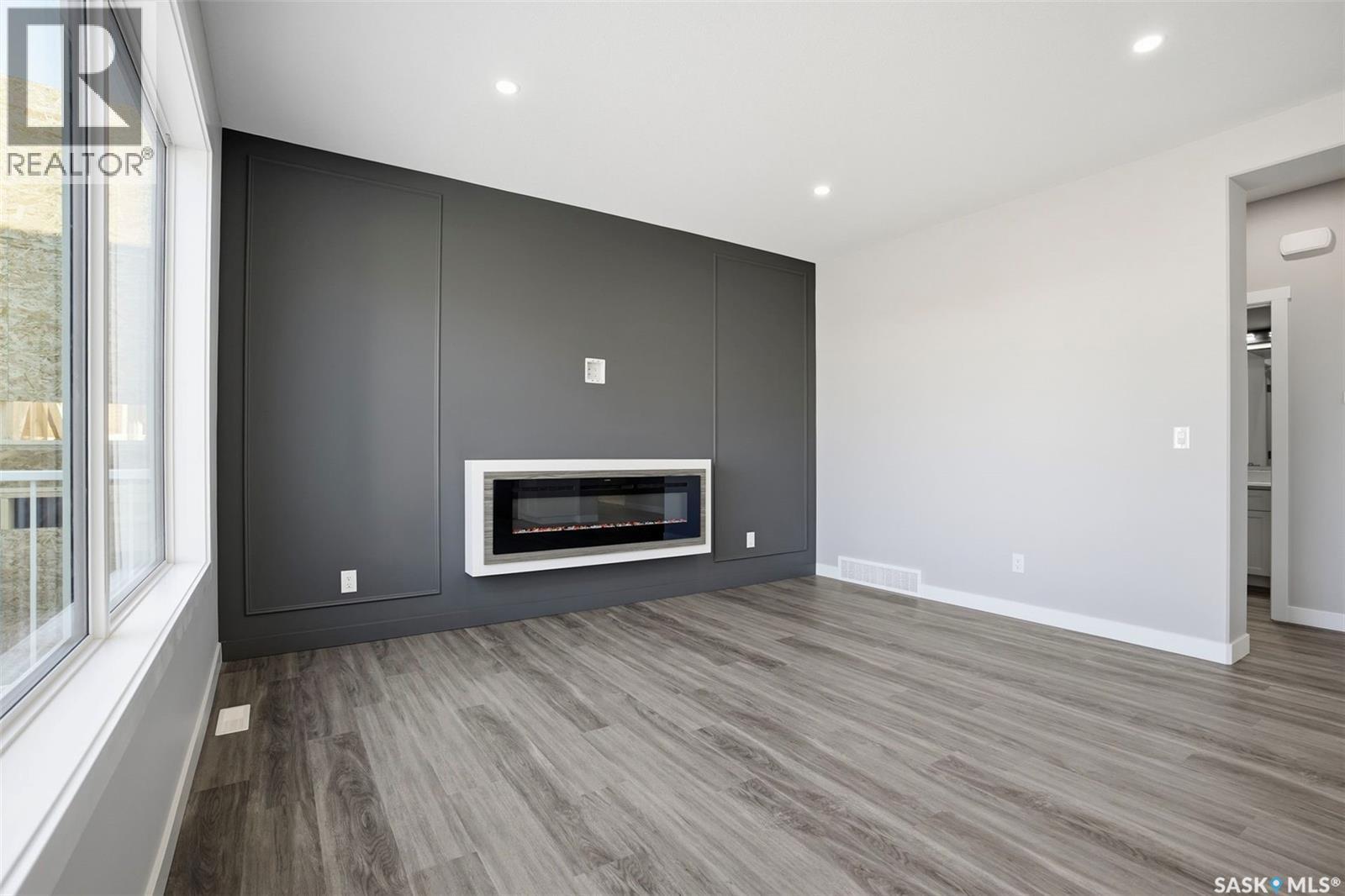 203 Sharma Lane, Saskatoon, SK - Indoor Photo Showing Living Room With Fireplace