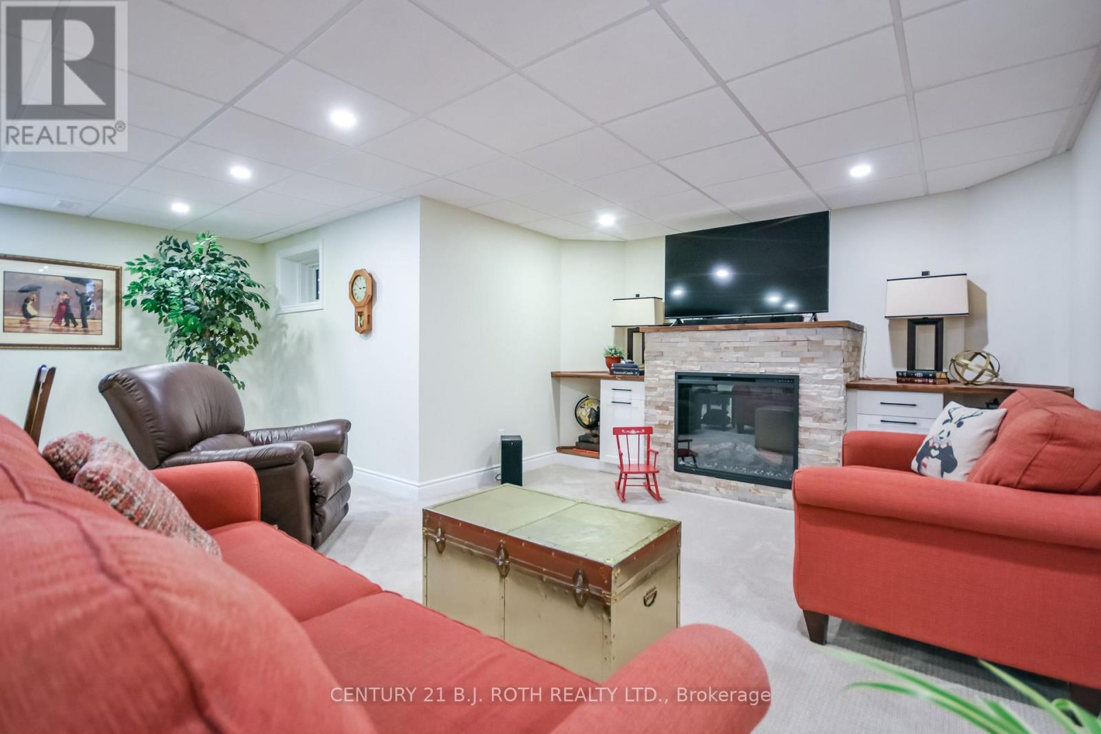 Huge lower level great room w above grade windows. - 91 Benson Drive, Barrie, ON - Indoor Photo Showing Living Room With Fireplace