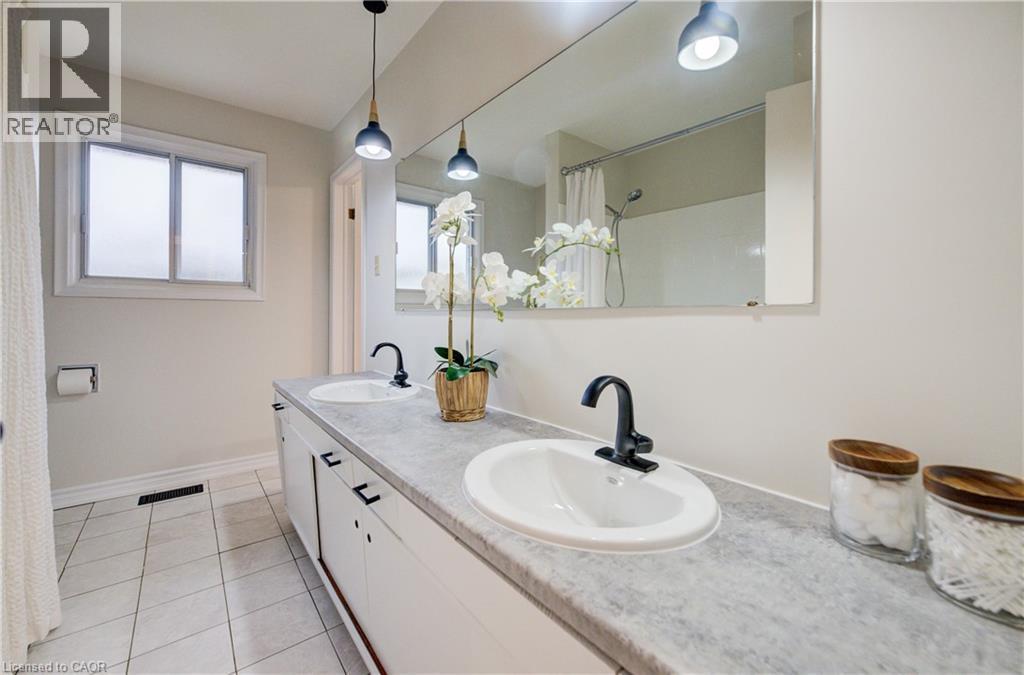 5pc bathroom with two sinks, bathtub/shower and brand new lighting. - 66 Tupper Crescent, Kitchener, ON - Indoor Photo Showing Bathroom