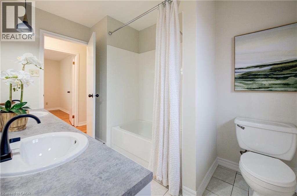 5pc bathroom with two sinks, bathtub/shower and brand new lighting. - 66 Tupper Crescent, Kitchener, ON - Indoor Photo Showing Bathroom