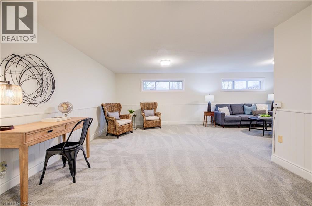 Brand new, plush carpet make this large rec-room cozy and comfortable. The large windows allow loads of natural light to pour in. - 66 Tupper Crescent, Kitchener, ON - Indoor