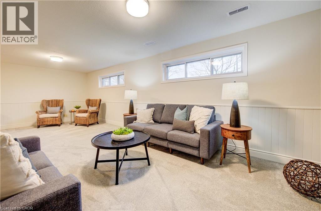 Orignal brickwork fireplace wall adds to the mid-century charm of this home. Cozy up next to the gas fireplace and relax with a good book. - 66 Tupper Crescent, Kitchener, ON - Indoor Photo Showing Living Room
