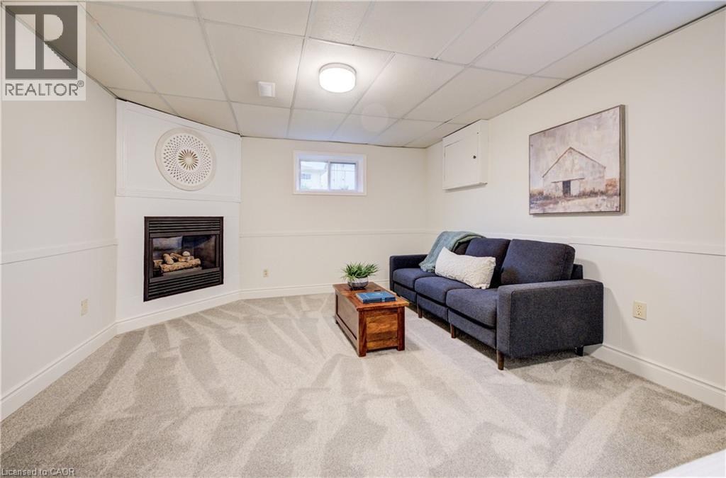 Basement 4th bedroom with lounge area and gas fireplace, a perfect spot for a teenager or in-law suite. - 66 Tupper Crescent, Kitchener, ON - Indoor Photo Showing Living Room With Fireplace