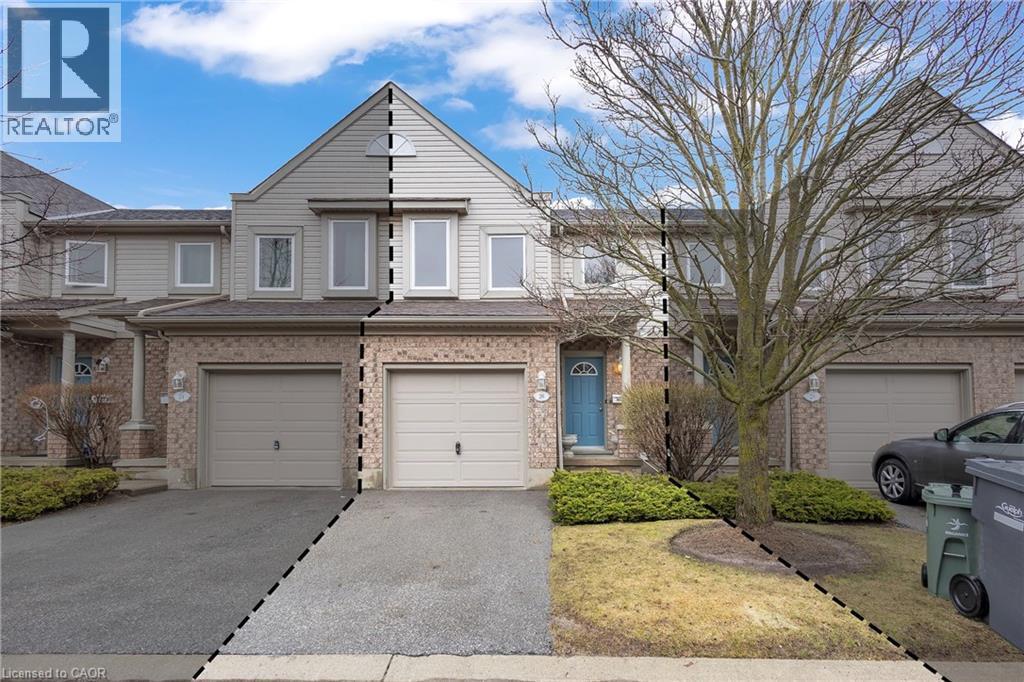 Traditional-style house with a garage, driveway, and brick siding - 26 Roehampton Crescent, Guelph, ON - Outdoor With Facade