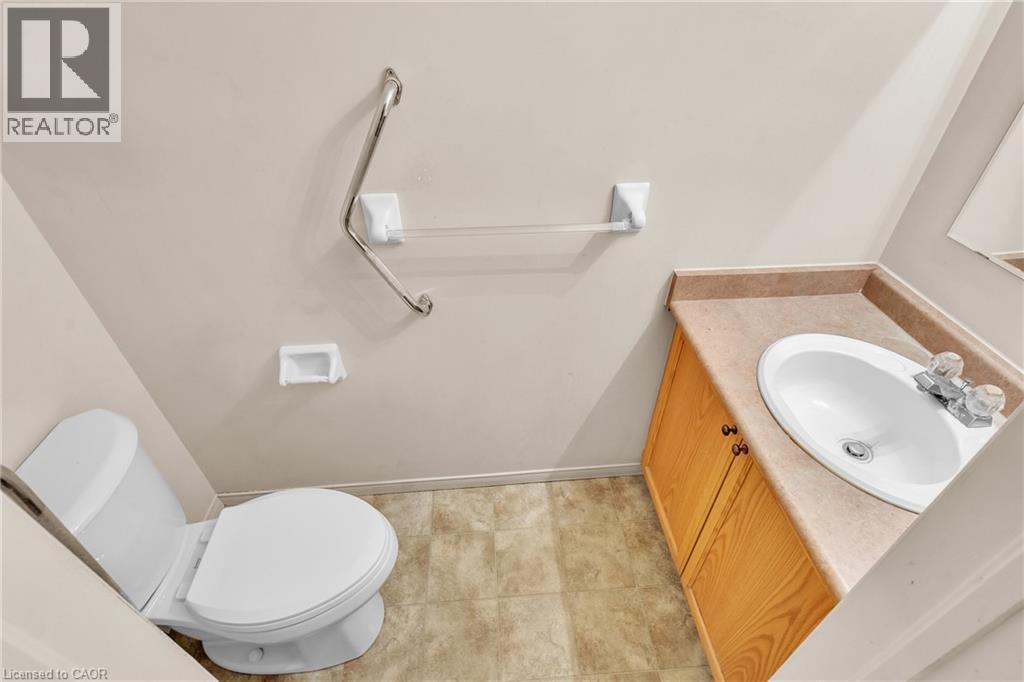 Half bath with vanity and toilet - 26 Roehampton Crescent, Guelph, ON - Indoor Photo Showing Bathroom