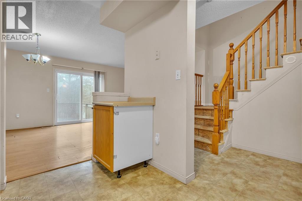 Kitchen with a textured ceiling, a chandelier, and light countertops - 26 Roehampton Crescent, Guelph, ON - Indoor Photo Showing Other Room