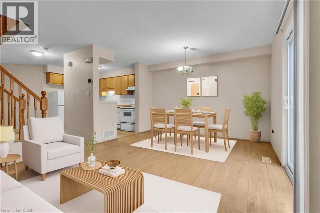 Living area with light wood-style floors and hanging lights - 26 Roehampton Crescent, Guelph, ON - Indoor Photo Showing Living Room
