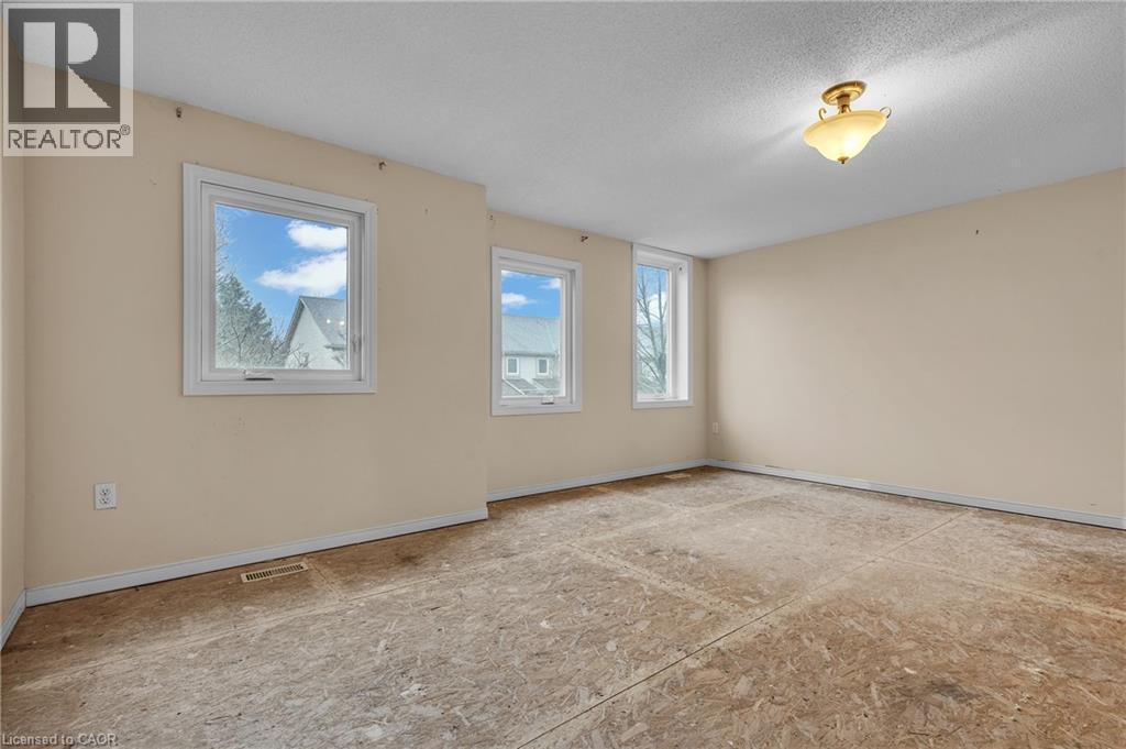 Unfurnished room featuring plenty of natural light and a textured ceiling - 26 Roehampton Crescent, Guelph, ON - Indoor Photo Showing Other Room