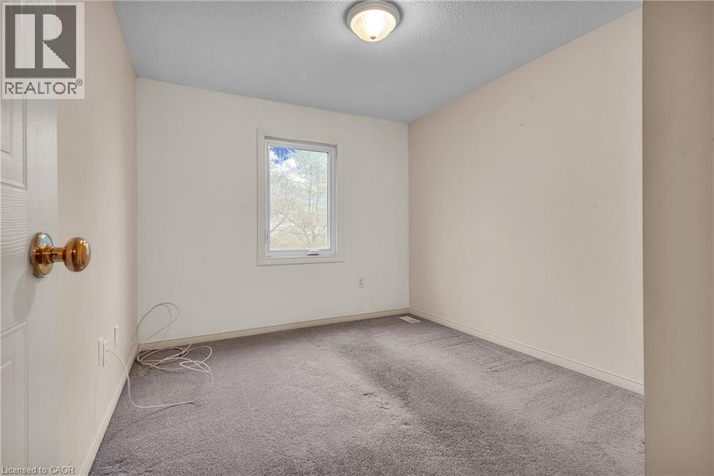 Spare room with light colored carpet and a textured ceiling - 26 Roehampton Crescent, Guelph, ON - Indoor Photo Showing Other Room