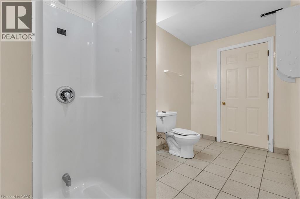 Bathroom featuring light tile patterned flooring and a shower - 26 Roehampton Crescent, Guelph, ON - Indoor Photo Showing Bathroom
