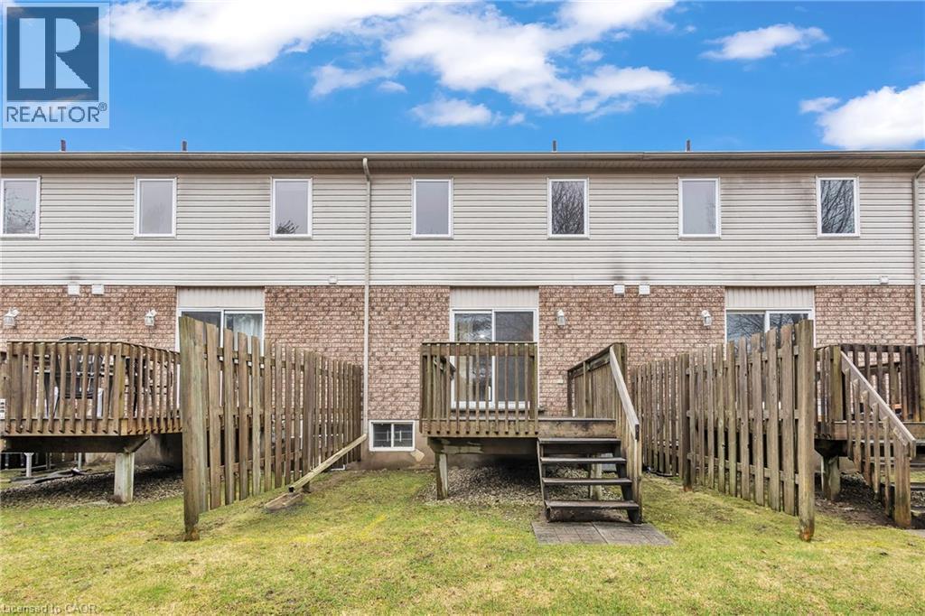 Rear view of property with a deck, a lawn, and brick siding - 26 Roehampton Crescent, Guelph, ON - Outdoor With Deck Patio Veranda With Exterior