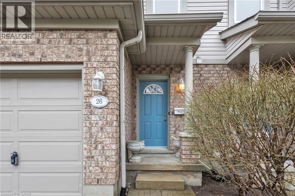 Entrance to property featuring stone siding, brick siding, and a garage - 26 Roehampton Crescent, Guelph, ON - Outdoor With Exterior