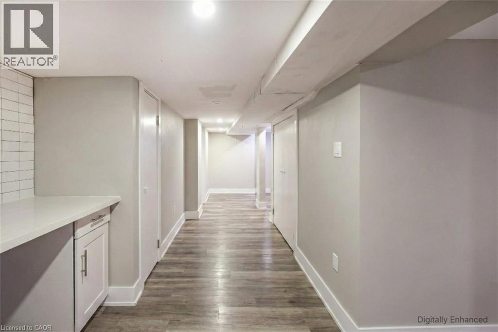 Hall with baseboards and dark wood-type flooring - 27 Ashley Street, Hamilton, ON - Indoor Photo Showing Other Room